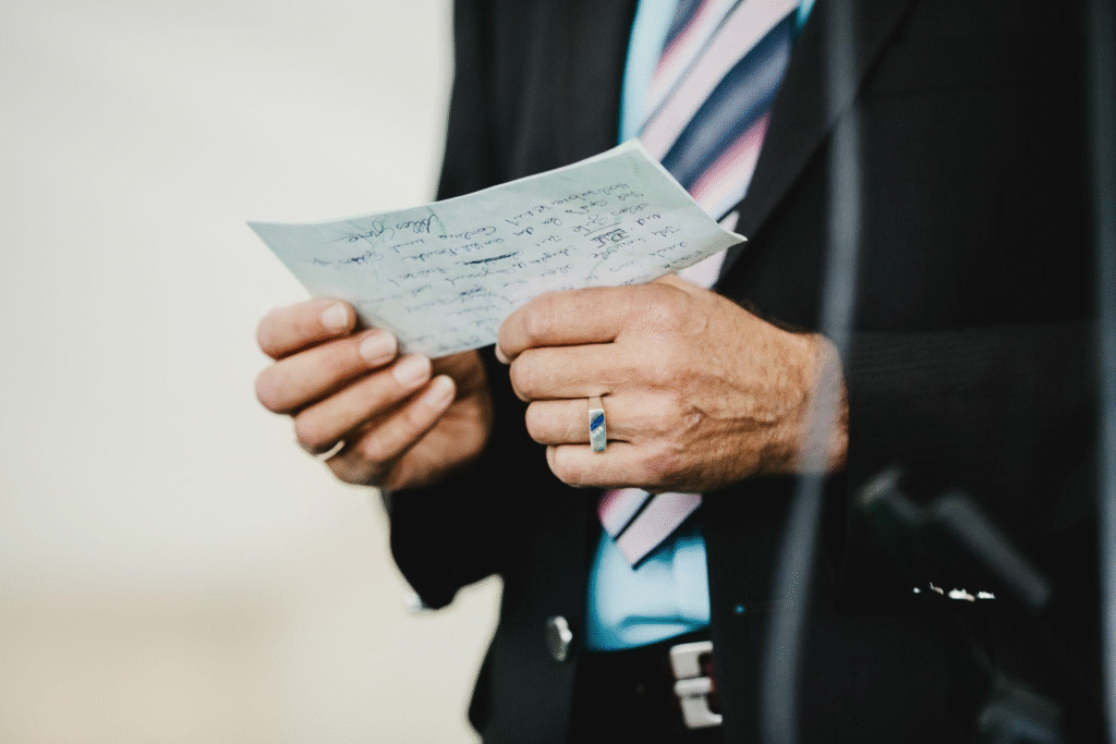 Old man holds a card in his arms