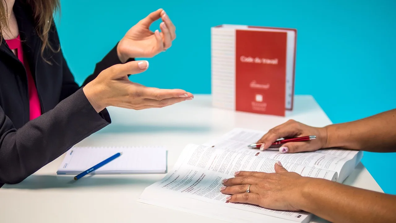 Two people discussing while filing a complaint