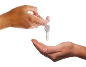 A person providing house keys to the other person