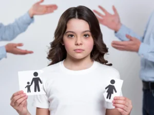 A young girl torn between parents with parents arguing in the back